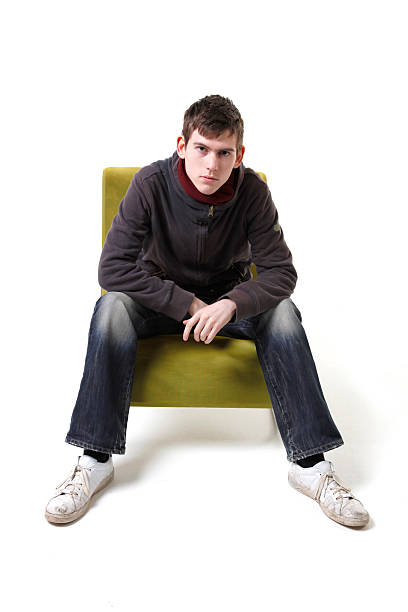 istock Young casual guy seated on green chair 119029927