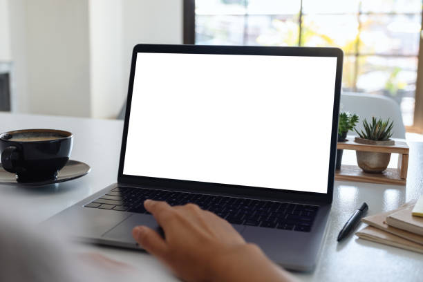 istock a hand using and touching on laptop touchpad with blank white desktop screen with coffee cup on wooden table 1190302243