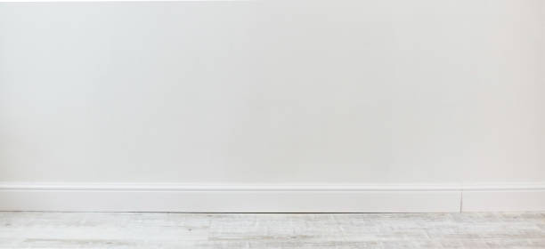istock Empty room with white cement wall texture and white wooden floor pattern. 1190303733