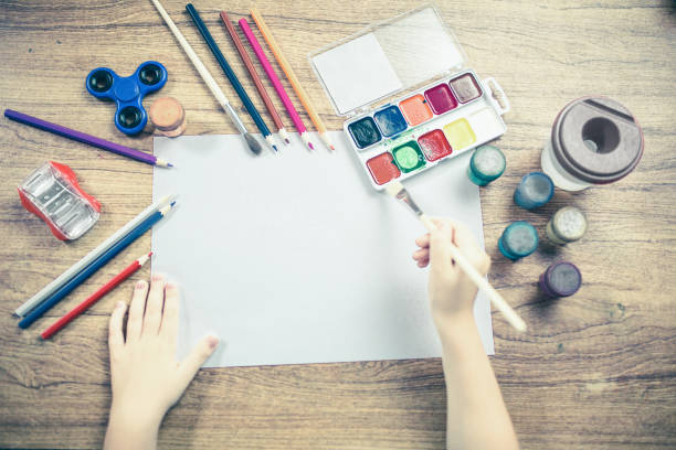 istock child paints with colored pencils 1190305485