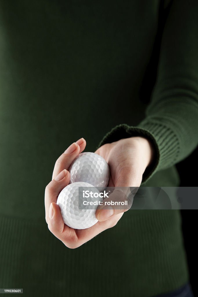 Nahaufnahme Schuss von eine weibliche hand holding zwei Golfbälle - Lizenzfrei Ausrüstung und Geräte Stock-Foto