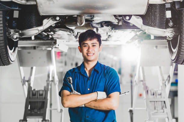 Portrait of Asian mechanic with repair equipment stock photo