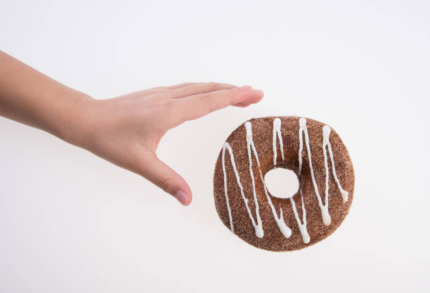 istock Donut or Donuts with hand on a background 1190313887