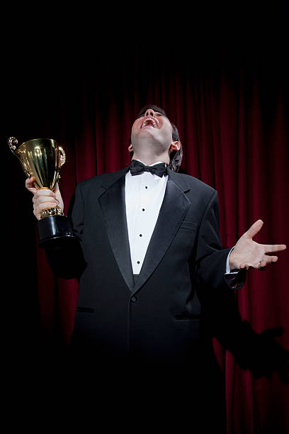 istock Excited man in tuxedo with trophy 119031847