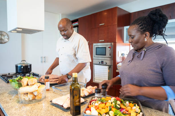 istock Senior African Couple Having Fun Cooking Together 1190319927