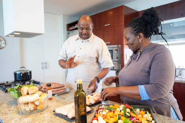 istock Senior African Couple Having Fun Cooking Together 1190319929