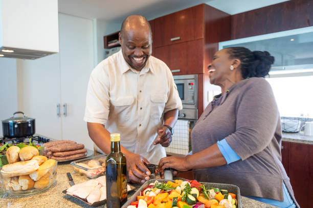 istock Senior African Couple Having Fun Cooking Together 1190319930