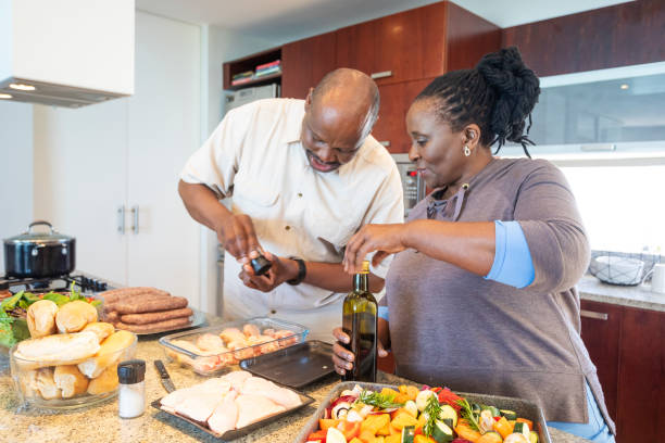 istock Senior African Couple Having Fun Cooking Together 1190319933