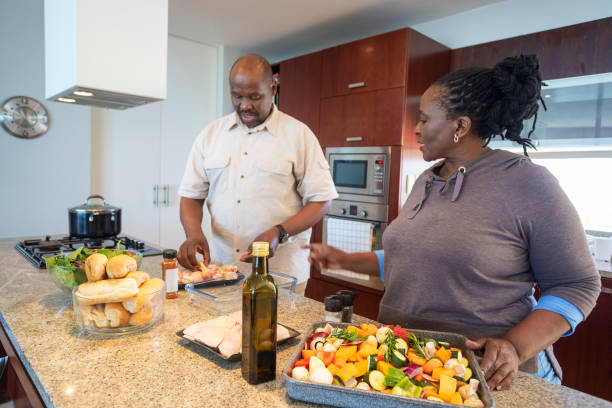 istock Senior African Couple Having Fun Cooking Together 1190319935