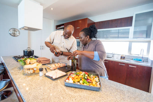 istock Senior African Couple Having Fun Cooking Together 1190319936