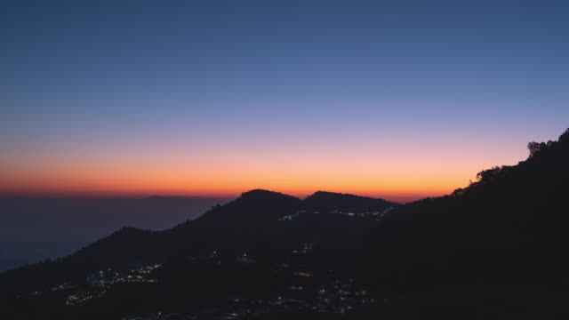 Timelapse of silhouette of mountain and city at sunrise time