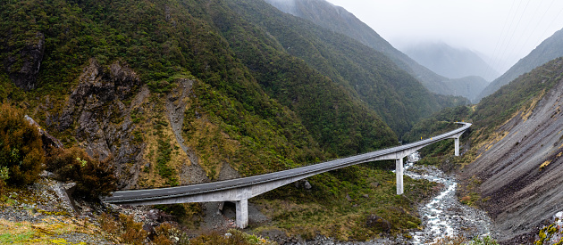 The viaduct at the top of Arthur's Pass in New Zealand, winding through the wild alpine landscape. Snow was just starting to fall as this photo was taken, driven through the pass by winds from the West Coast.