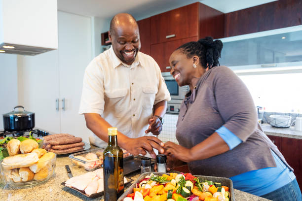 istock Senior African Couple Having Fun Cooking Together 1190323452