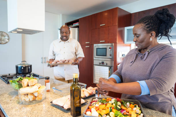 istock Senior African Couple Having Fun Cooking Together 1190323455