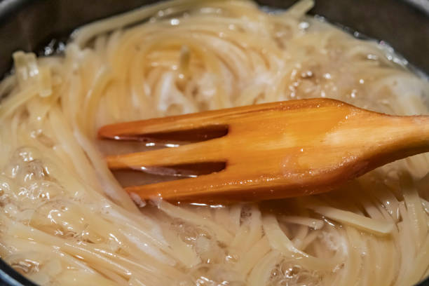 istock spaghetti pasta in pot and wooden fork 1190323735