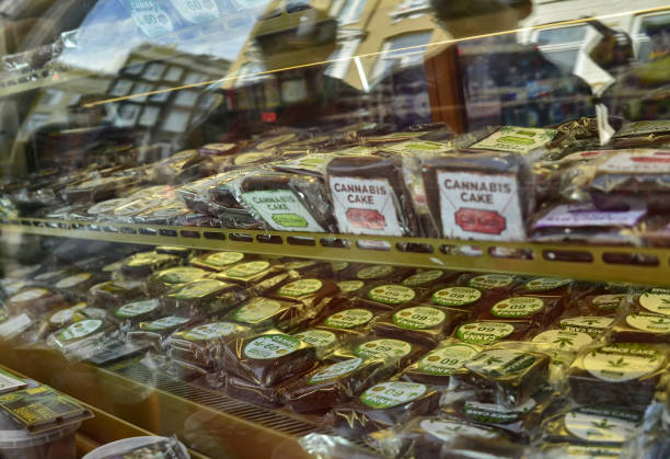 Amsterdam, Holland. August 2019. Amsterdam, Holland. August 2019. In the red light district, a store sells cannabis-based cookies and sweets. wellen stock pictures, royalty-free photos & images