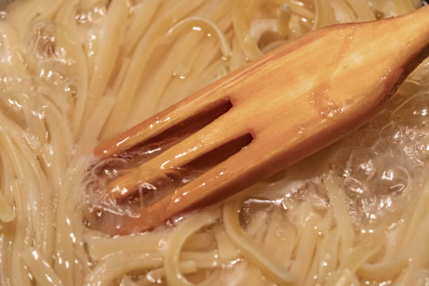 istock spaghetti pasta in pot and wooden fork 1190323843