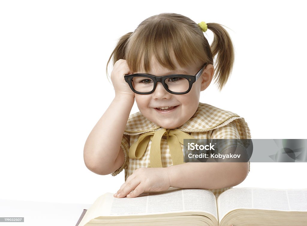 Happy little girl with books wearing black glasses  Activity Stock Photo