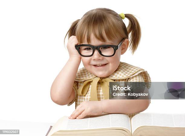 Happy Little Girl With Books Wearing Black Glasses Stock Photo - Download Image Now - Activity, Back to School, Book