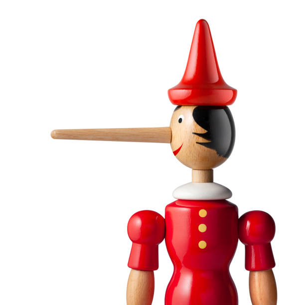 Lie. Pinocchio with a long nose. Lie. Pinocchio on white background. Photo with clipping path. political joke stock pictures, royalty-free photos & images