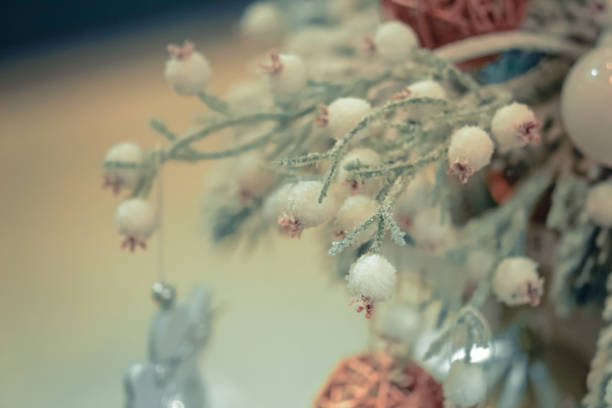 Christmas tree toys decorations and snow-covered Christmas tree branches close-up, spots white color. Winter Christmas New Year background.