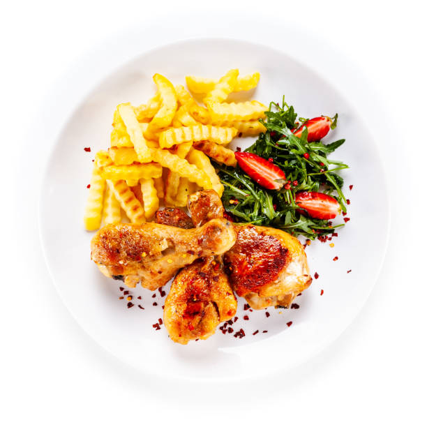 istock Roast chicken drumsticks with fried potatoes and vegetables 1190329731
