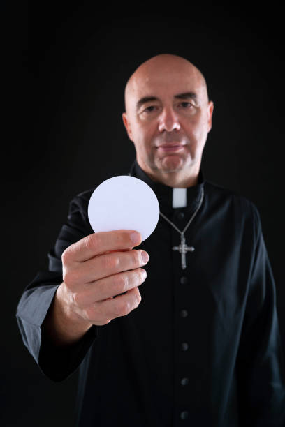 istock Priest holding communion wafer in eucharist 1190335674