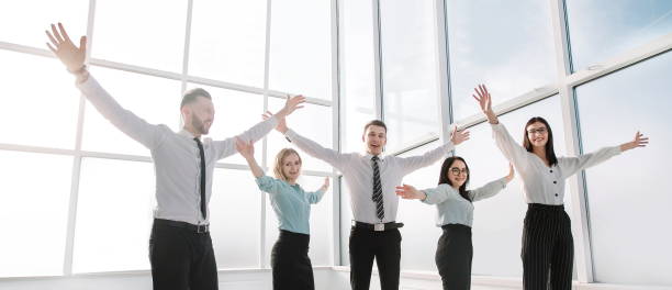 istock business team standing in spacious new office. 1190337778