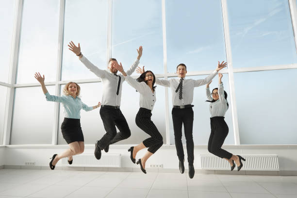 istock happy business team having fun in an empty new office. 1190337914