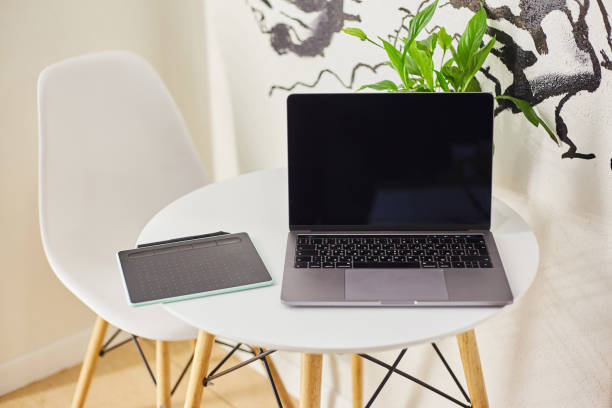 istock Laptop with a graphics tablet on a table in a cafe. 1190340566