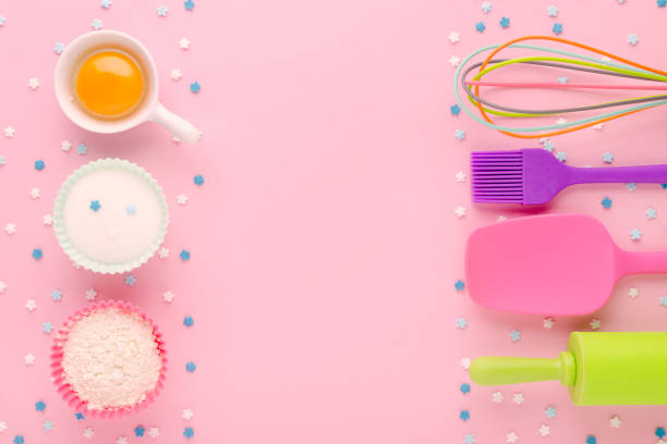 istock baking ingredients, egg, flour, sugar, sweet decoration and kitchen tools on pink background with copy space 1190342286