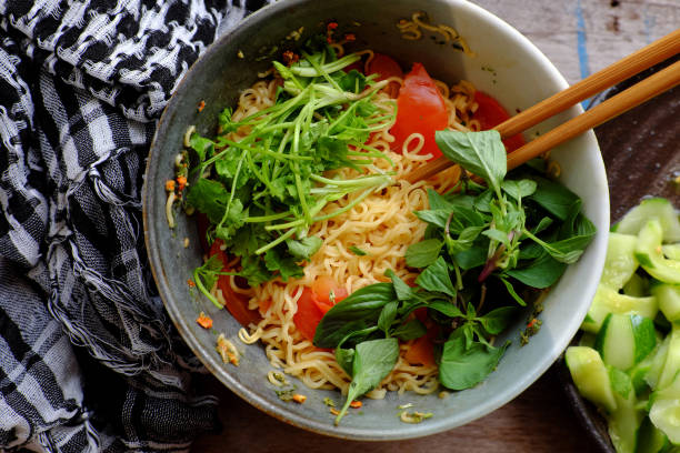 Vietnamese food, vegan instant noodles soup with tomato, quick meal for breakfast
