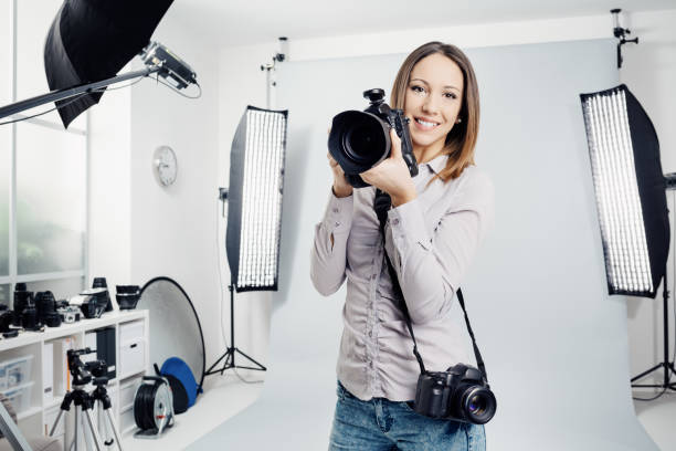 istock Young female photographer in the studio 1190347981