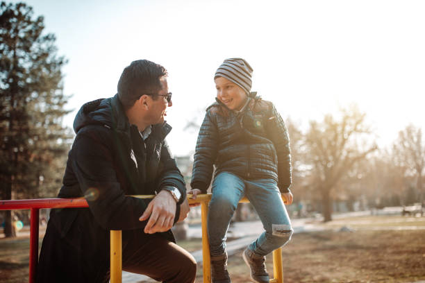 istock Father and son playing in park 1190349198