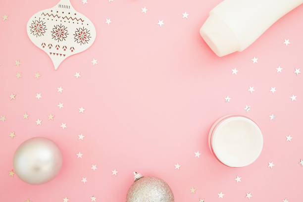 istock Christmas composition with decoration, confetti and shampoo bottle on pink. Flat lay, top view. Feminine beauty concept 1190350804