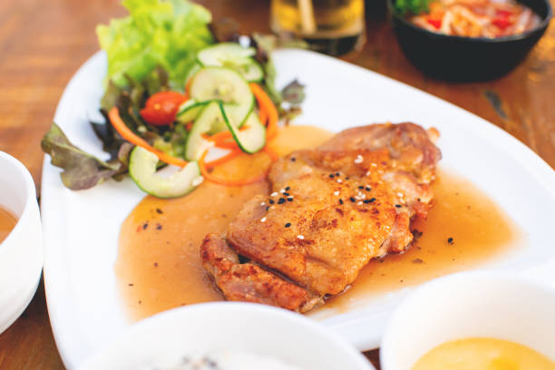 Korean grilled pork with vegetable salad on a white plate