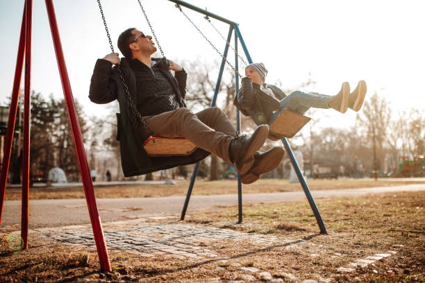 istock Father and son having fun in park 1190350955