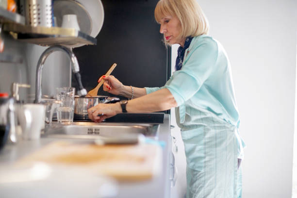 istock Senior woman stirring tomato sauce 1190351398