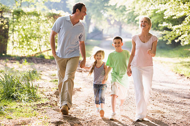istock Family running outdoors holding hands 119035248