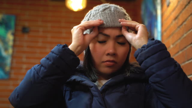 Asian woman wearing winter hat and getting ready to going out