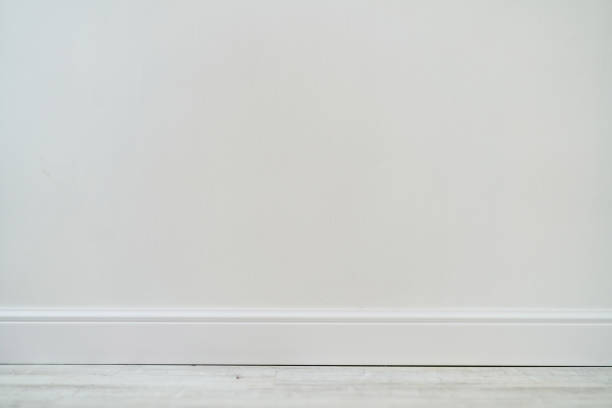 istock Empty room with white cement wall texture and white wooden floor pattern. 1190355686