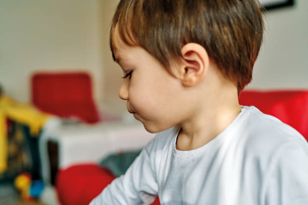istock 2-3 years old child playing alone at living room. 1190355799