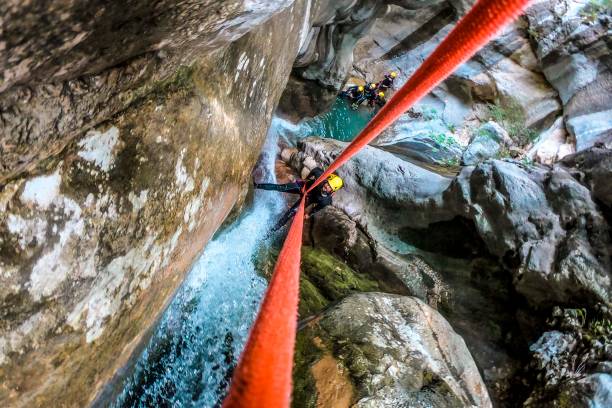 istock A high angle view of a canyoneer making a descent down a small waterfall in a canyon 1190356241