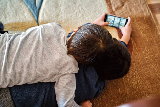 istock Child playing smart phone. 1190357034