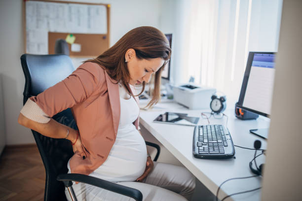 istock Pregnant working woman with back ache 1190358900