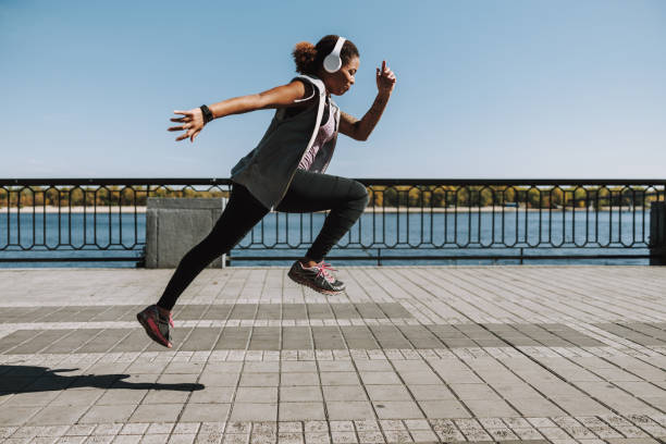 istock Charming Afro American lady jumping on the street 1190359029