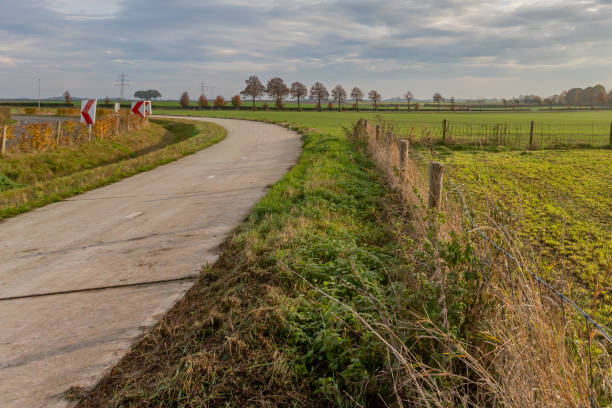 istock Bicycle lane beside a road with dangerous curve marking 1190360334