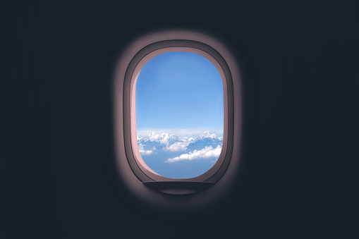 Ventana del avión. Vista de montaña y nubes photo