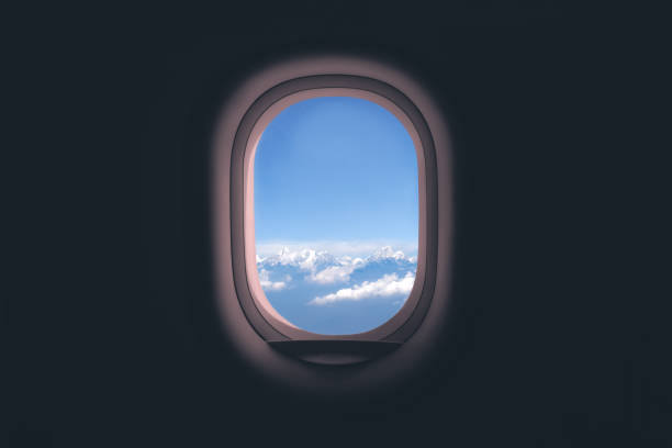 Airplane window. Mountain and clouds view stock photo