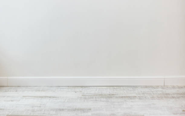 istock Empty room with white cement wall texture and white wooden floor pattern. 1190360390